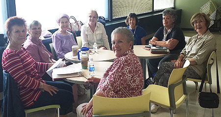 A photo of the book group members having their monthly meeting in the OLLI Lounge