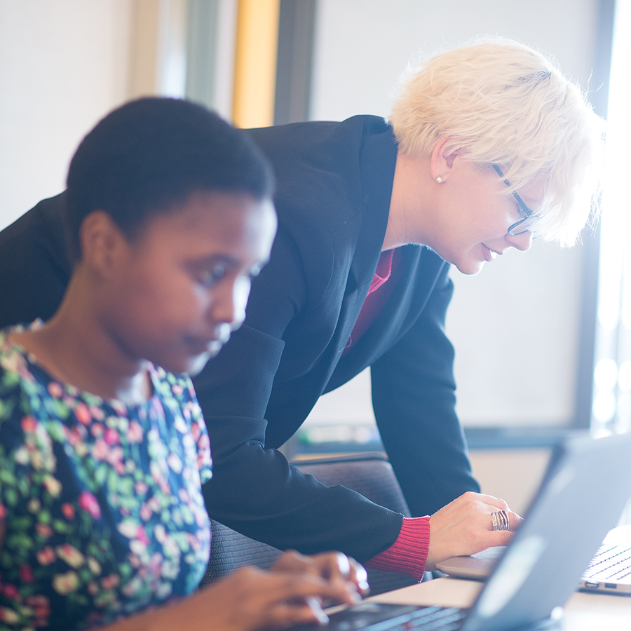 graduate students on laptop with light illuminating from window