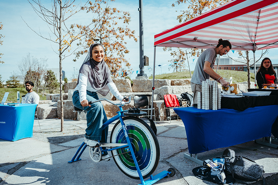 Student riding bicycle at Beacon Wellness Walk Resource Fair