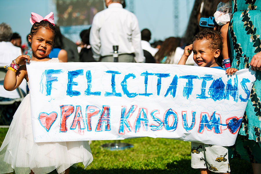 Family holding a sign at commencement