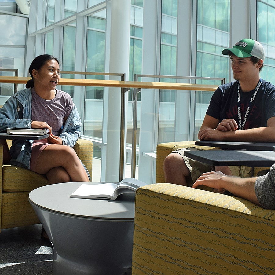 Two students talk in ISC lounge.