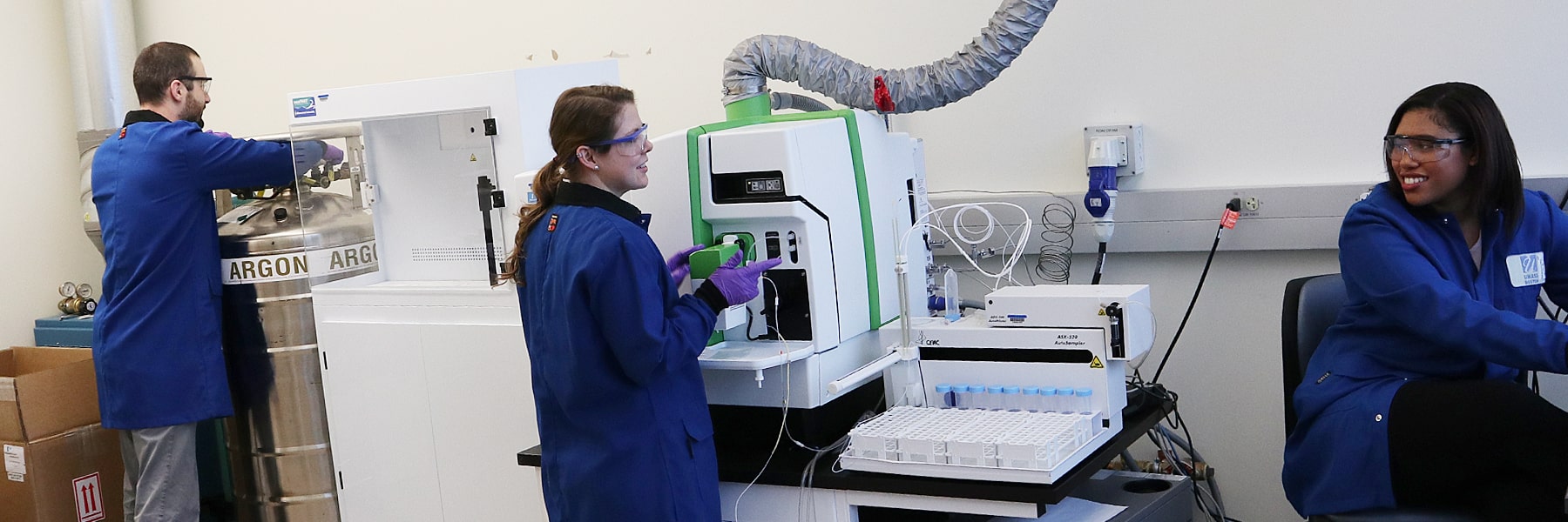 graduate students using lab equipment