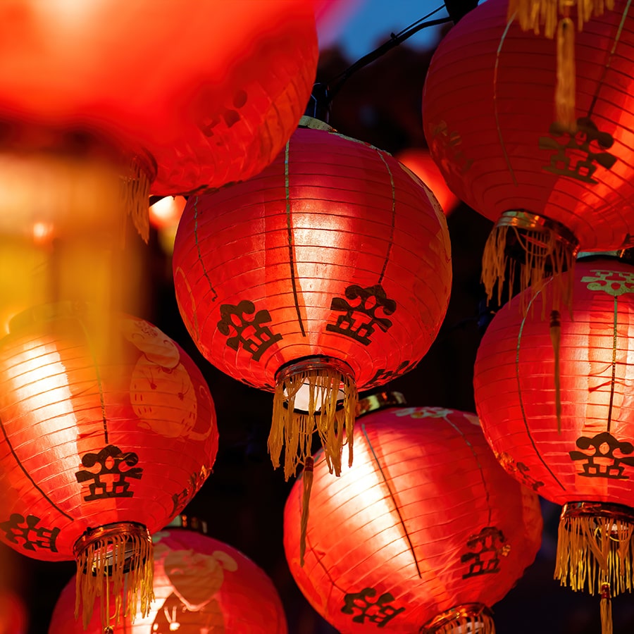 Rows of colorful glowing red Chinese lanterns