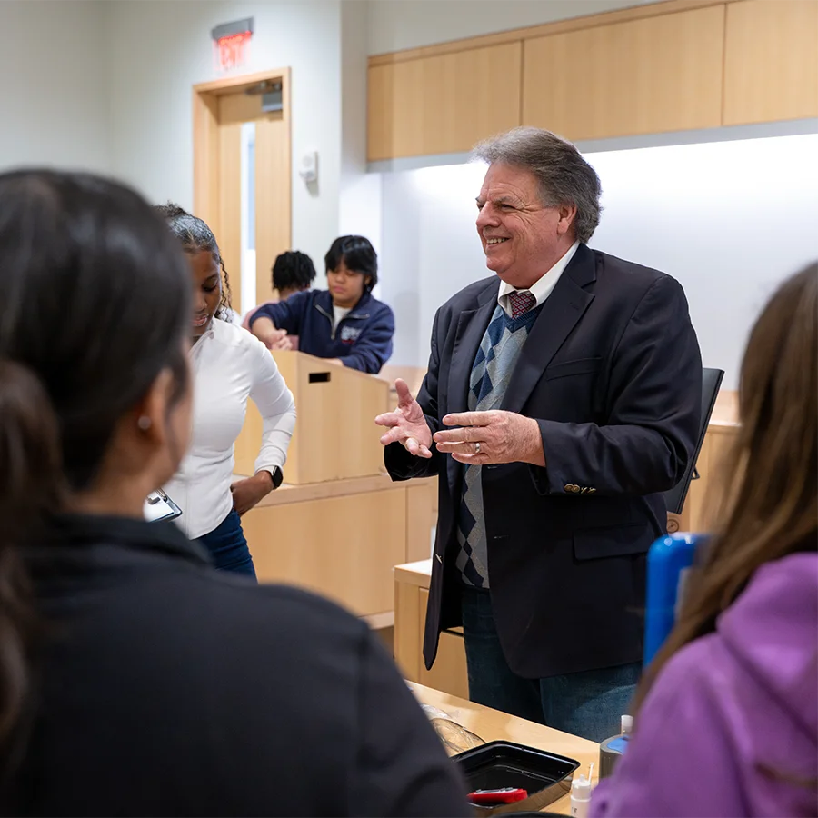 Professor of Public Health instructs students in a classroom.