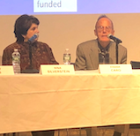 two people speaking at panel