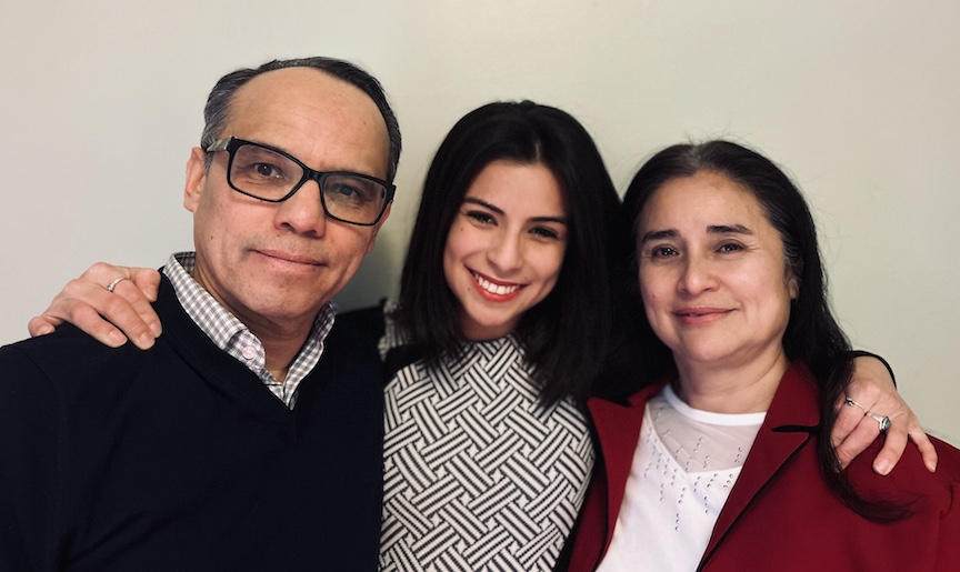 portrait of doctoral student with mother and father