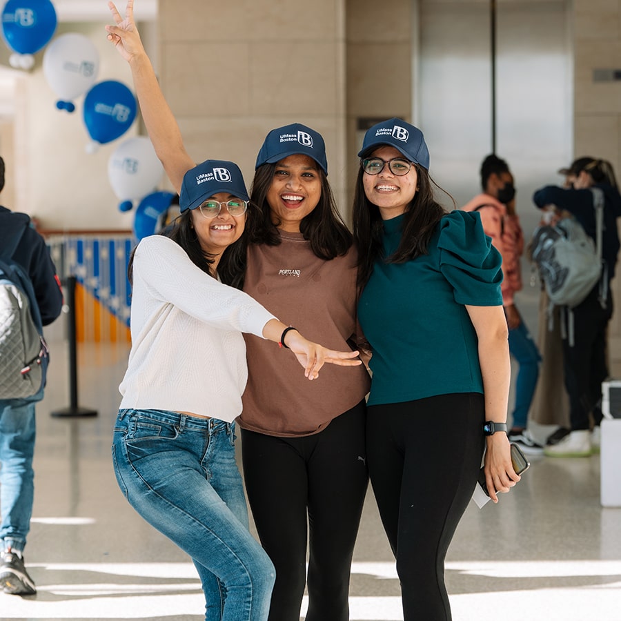 Three UMass Boston students pose at Beacon Spirit Days