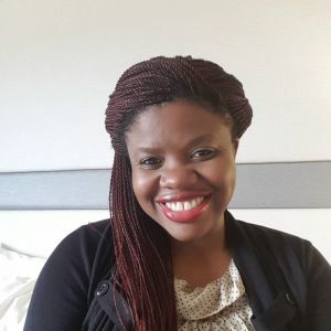 woman smiling at camera wearing a black jacket